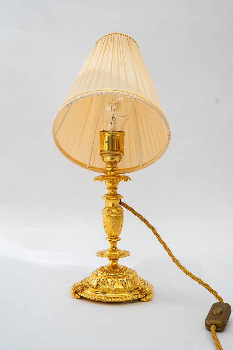 Historistic fire gilted table lamp with fabric shade vienna around 1890s
