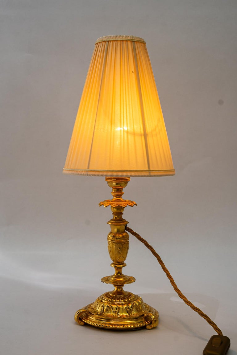 Historistic fire gilted table lamp with fabric shade vienna around 1890s