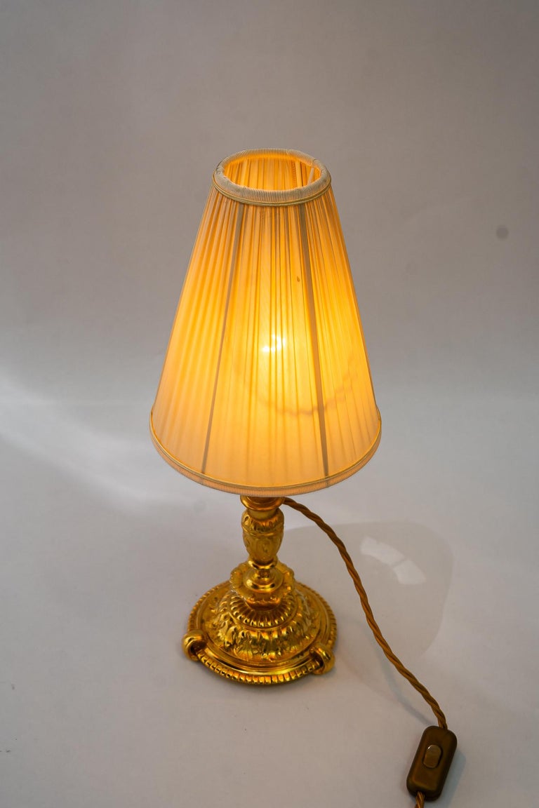 Historistic fire gilted table lamp with fabric shade vienna around 1890s