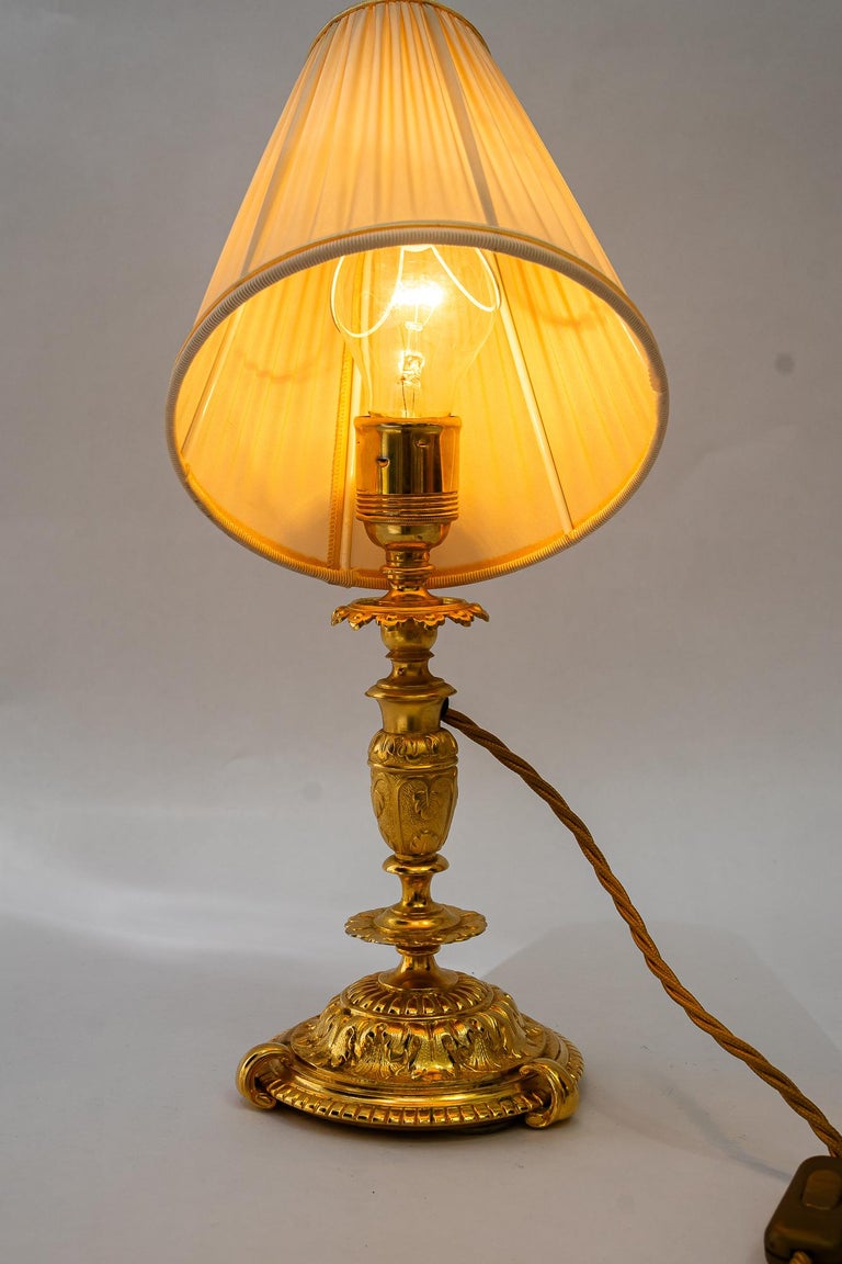 Historistic fire gilted table lamp with fabric shade vienna around 1890s