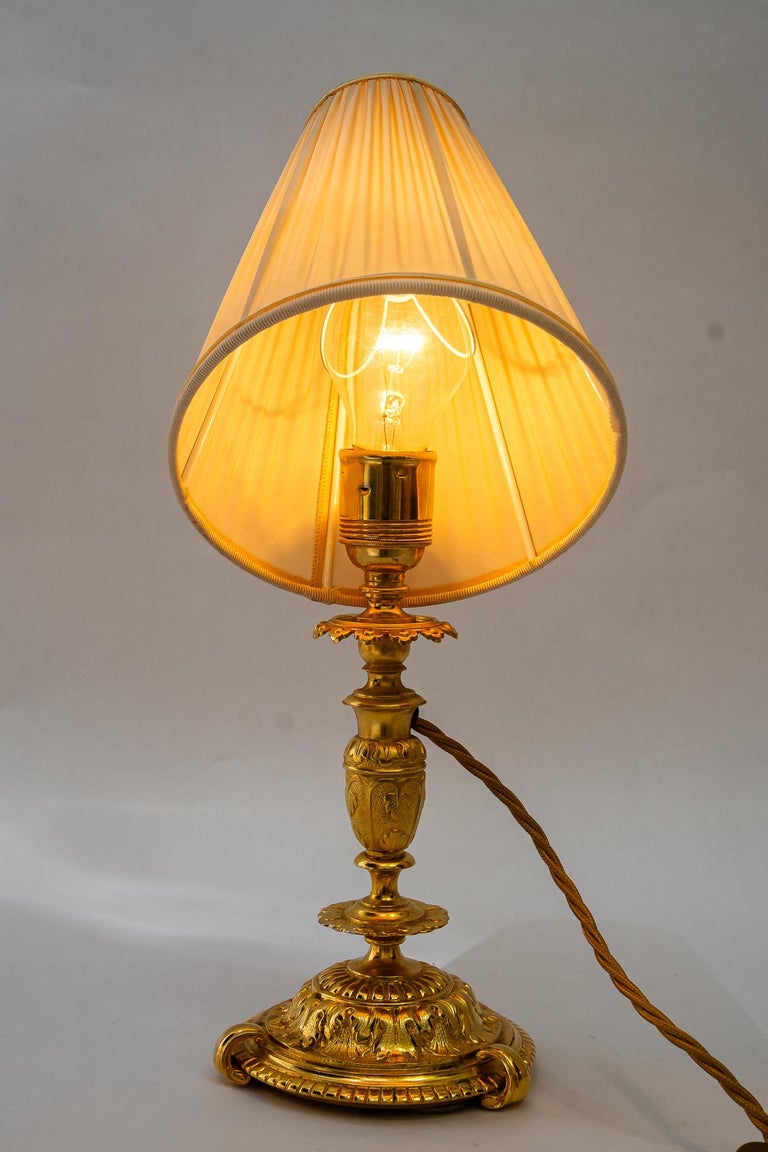 Historistic fire gilted table lamp with fabric shade vienna around 1890s