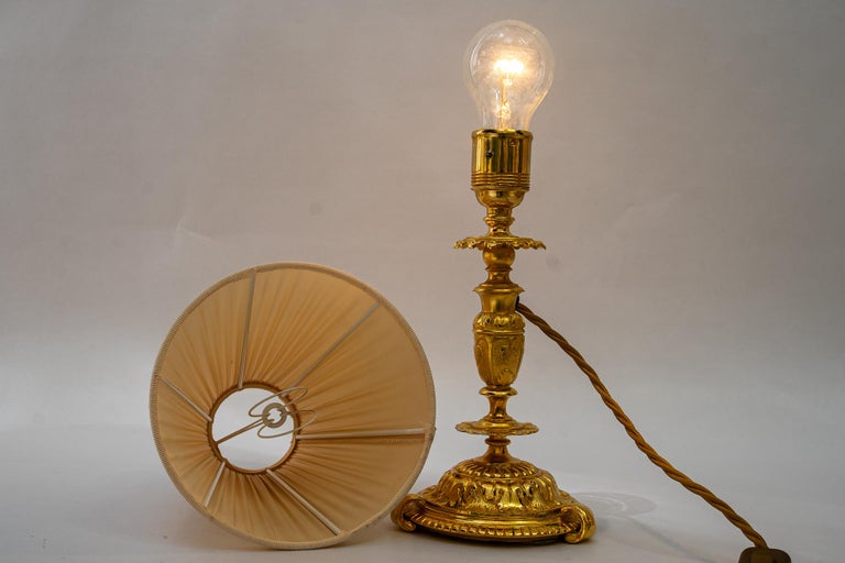 Historistic fire gilted table lamp with fabric shade vienna around 1890s