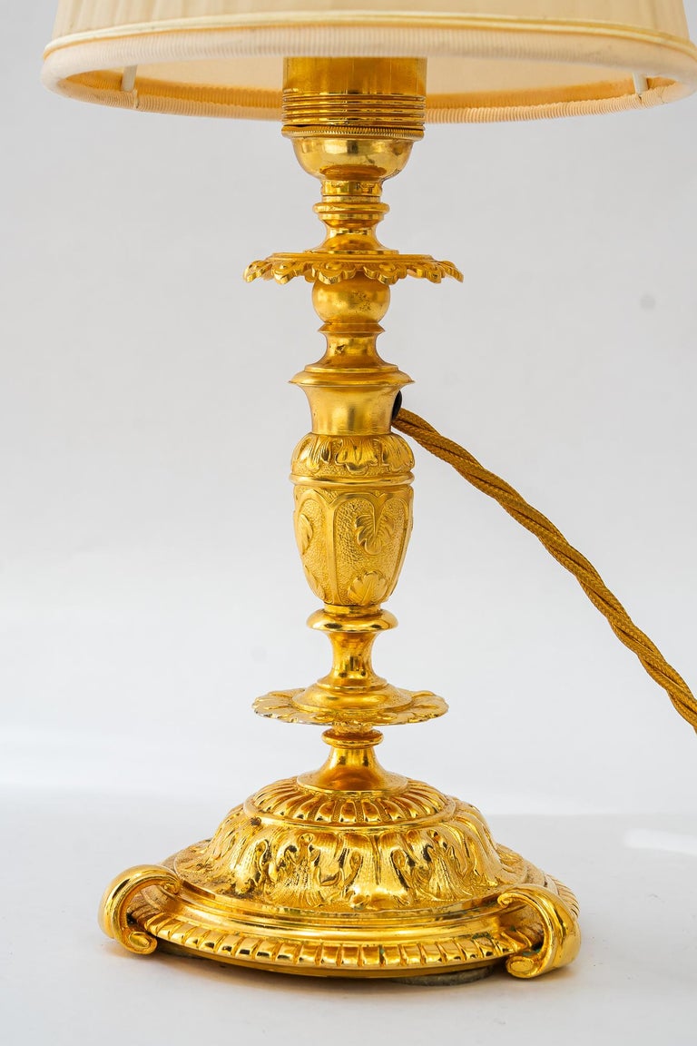 Historistic fire gilted table lamp with fabric shade vienna around 1890s