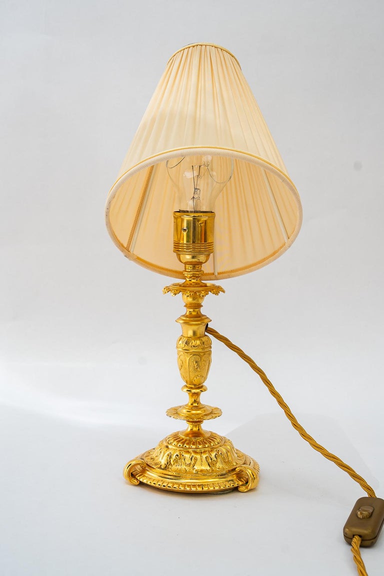 Historistic fire gilted table lamp with fabric shade vienna around 1890s