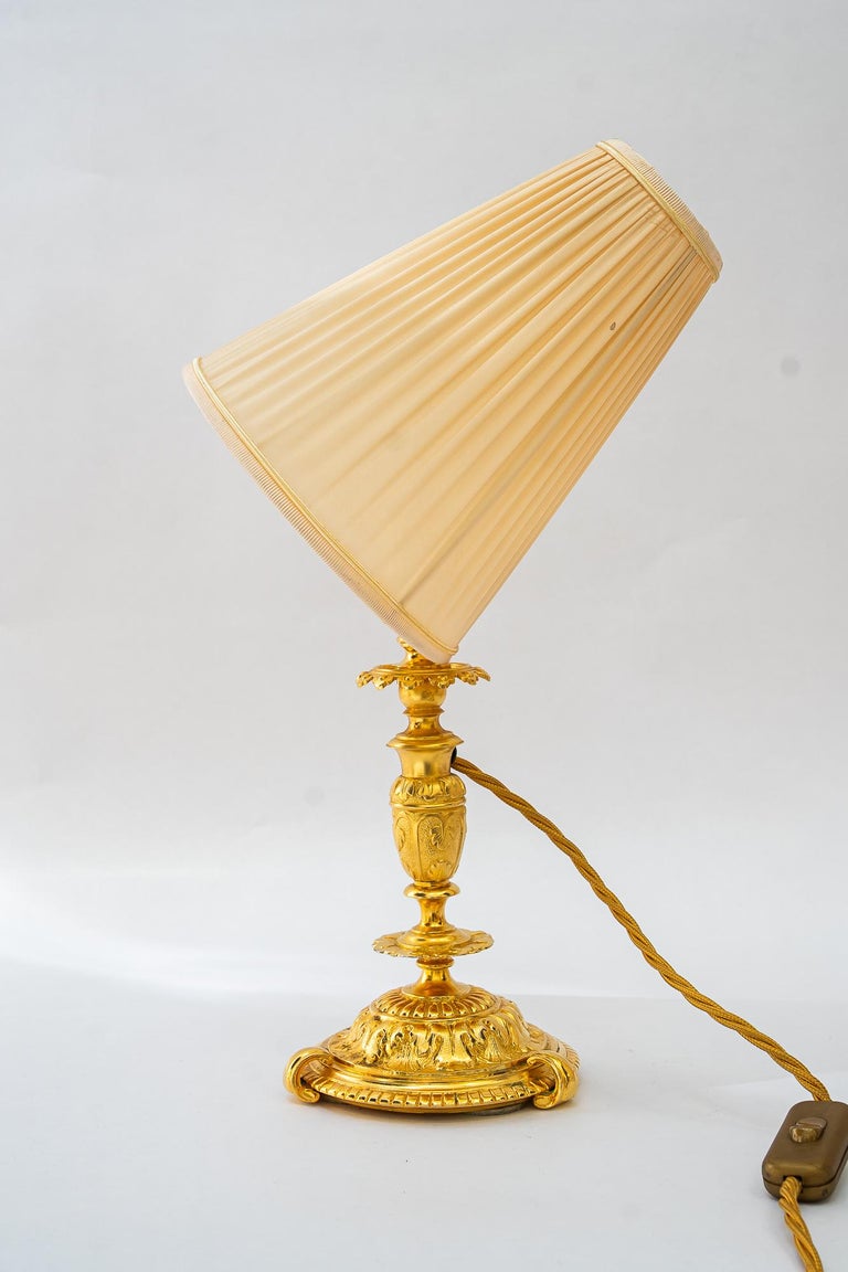 Historistic fire gilted table lamp with fabric shade vienna around 1890s