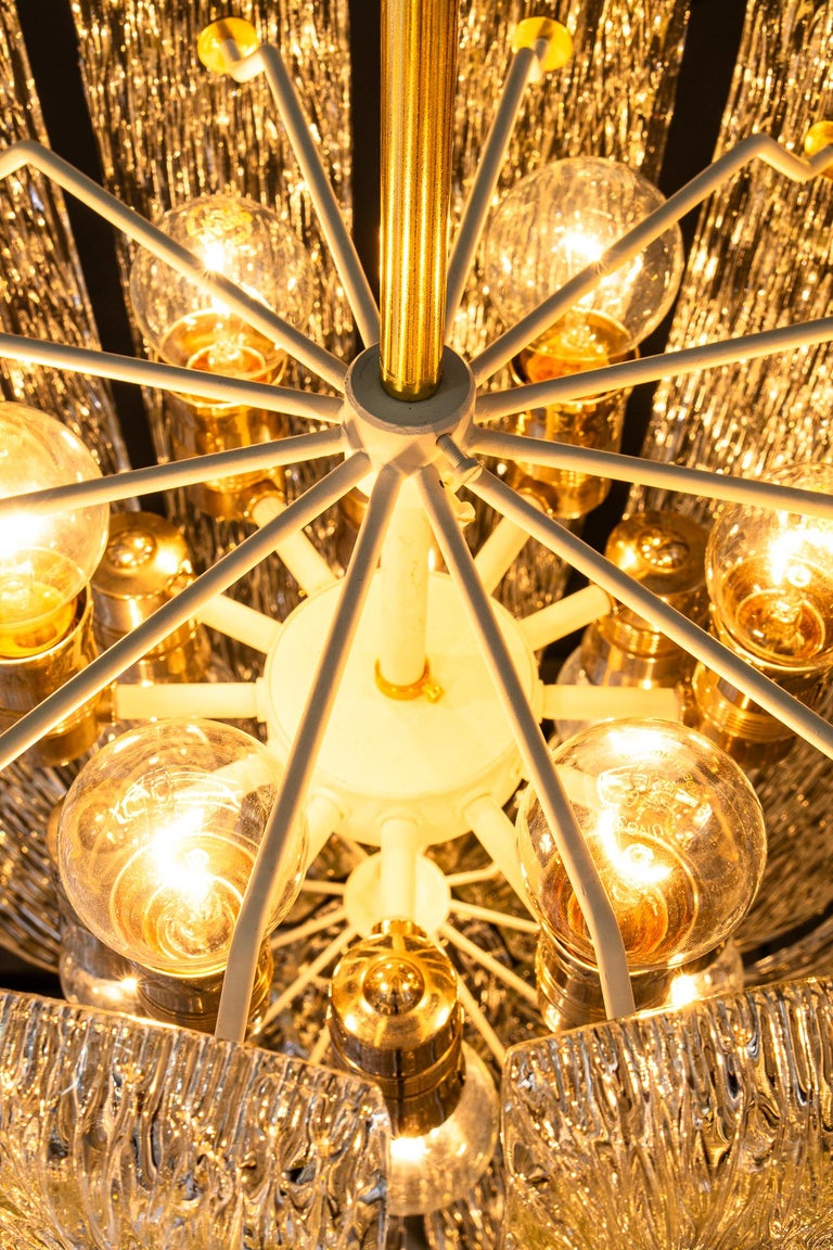 Modern mid century chandelier with brass and curved textured glass by J.T Kalmar