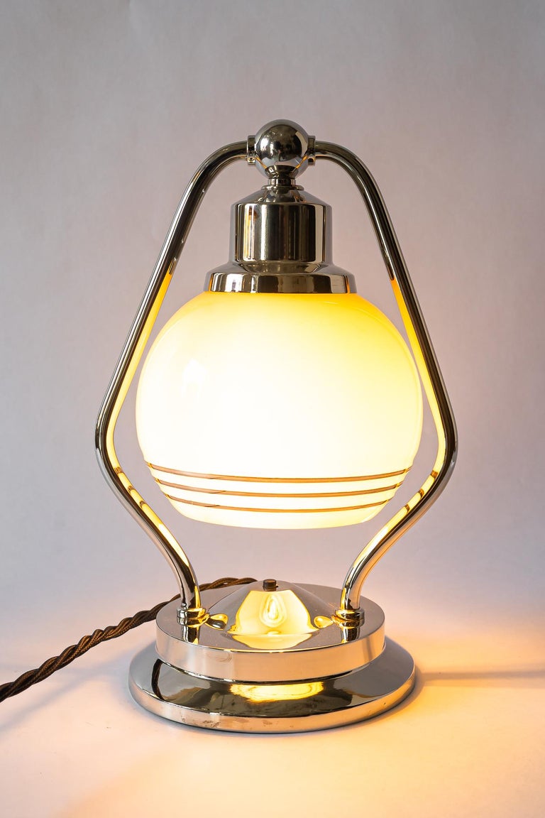 Swiveling Art Deco nickel table lamp with glass vienna around 1920s