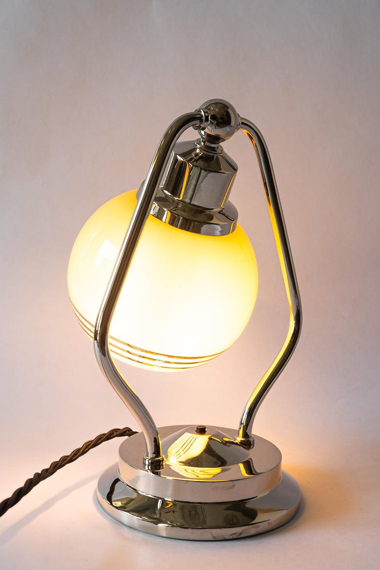 Swiveling Art Deco nickel table lamp with glass vienna around 1920s