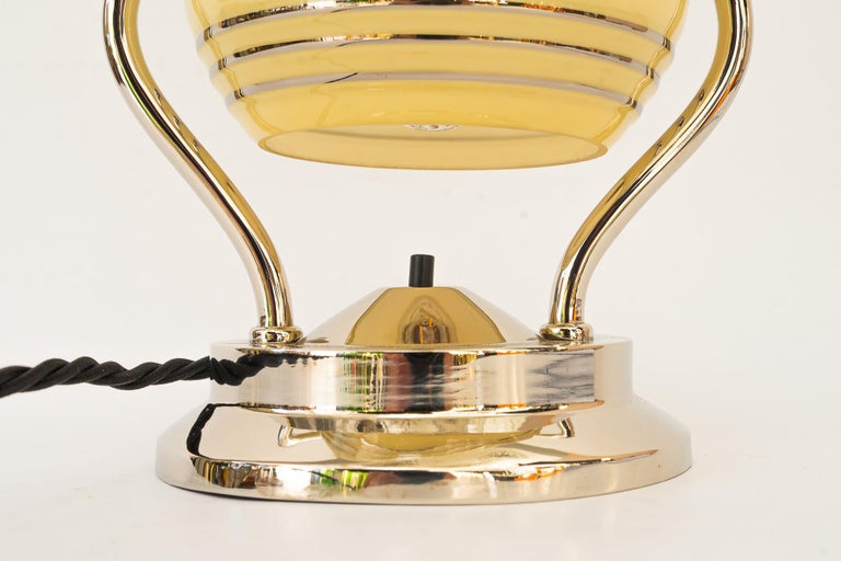 Swiveling Art Deco nickel table lamp with glass vienna around 1920s