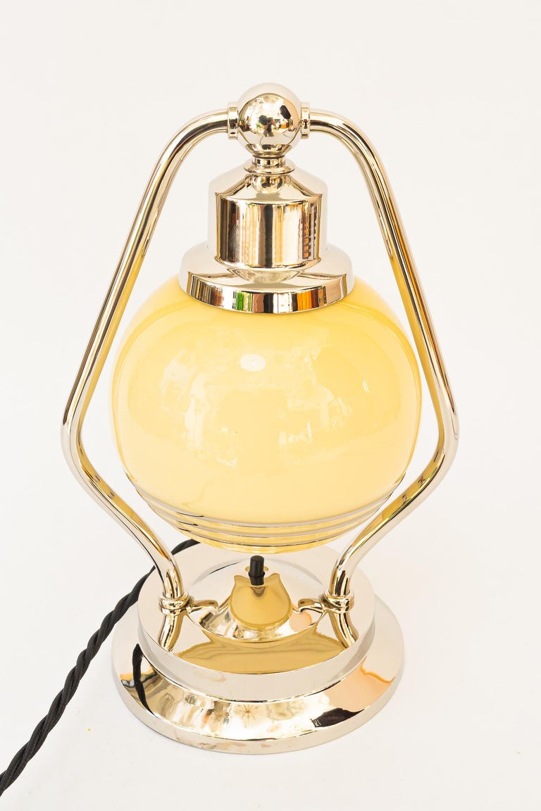 Swiveling Art Deco nickel table lamp with glass vienna around 1920s