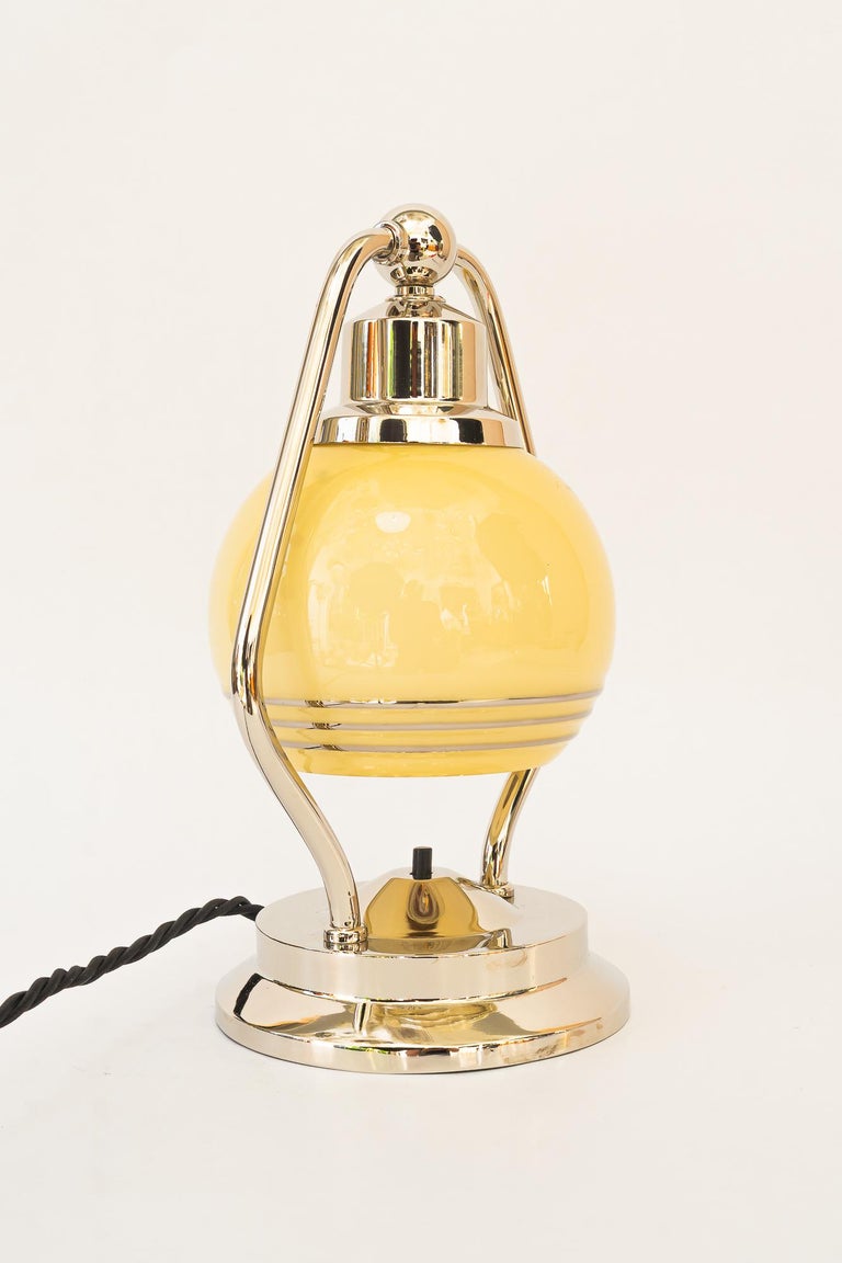 Swiveling Art Deco nickel table lamp with glass vienna around 1920s