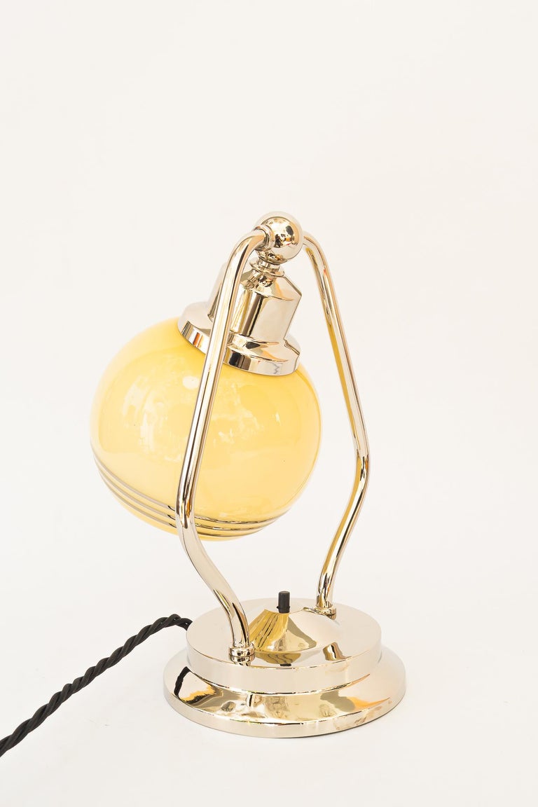 Swiveling Art Deco nickel table lamp with glass vienna around 1920s