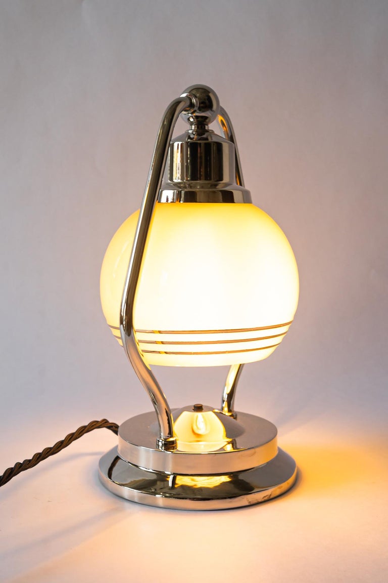 Swiveling Art Deco nickel table lamp with glass vienna around 1920s
